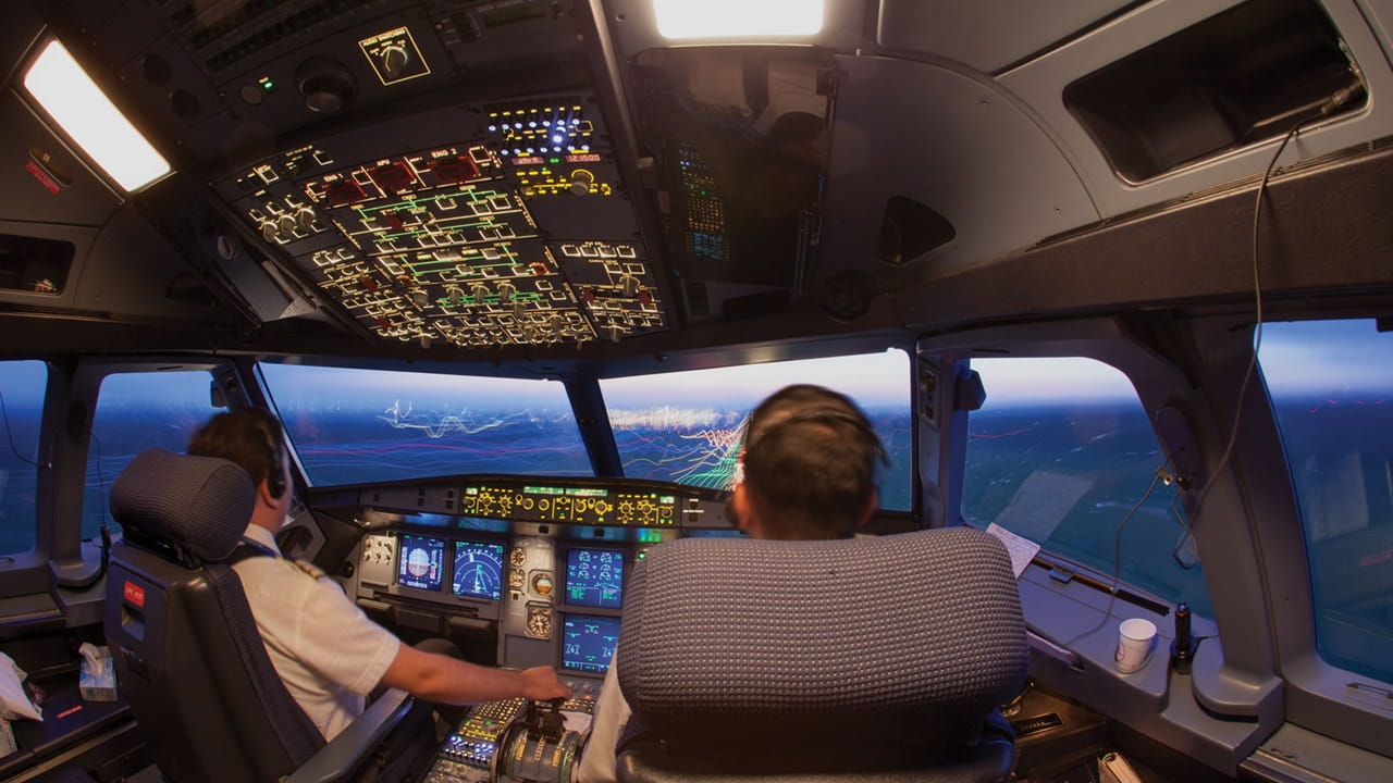 two pilots in the cockpit of an airplane