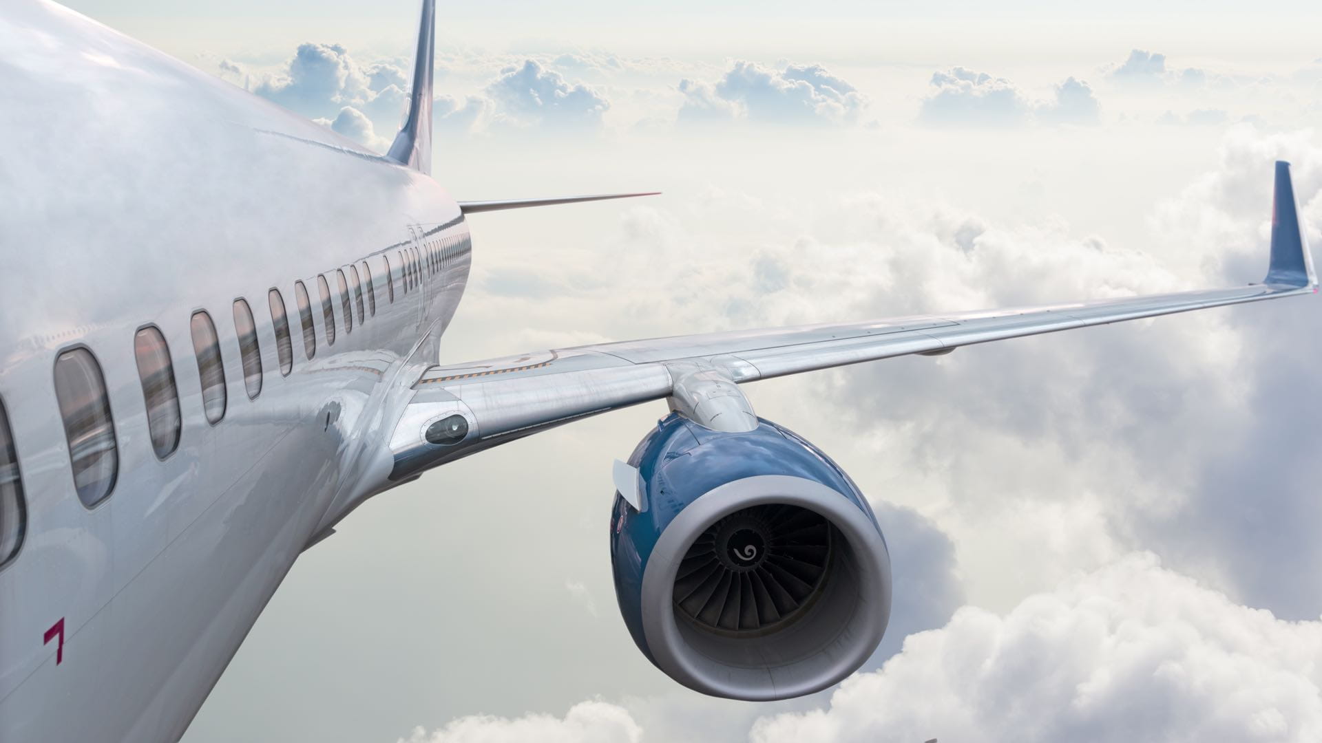a photograph of an airplane wing and the turbine