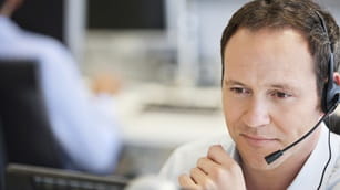 man working in customer service talking in a microphone