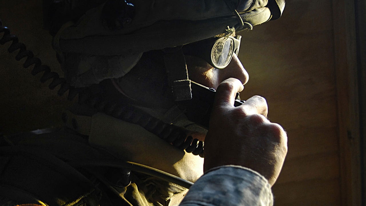 Military person communicating on a radio