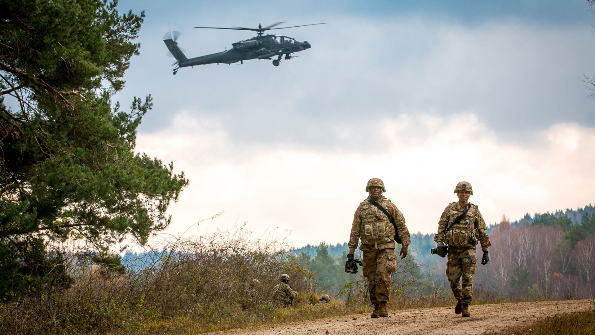 Two army officers walking down a trial during training exercise