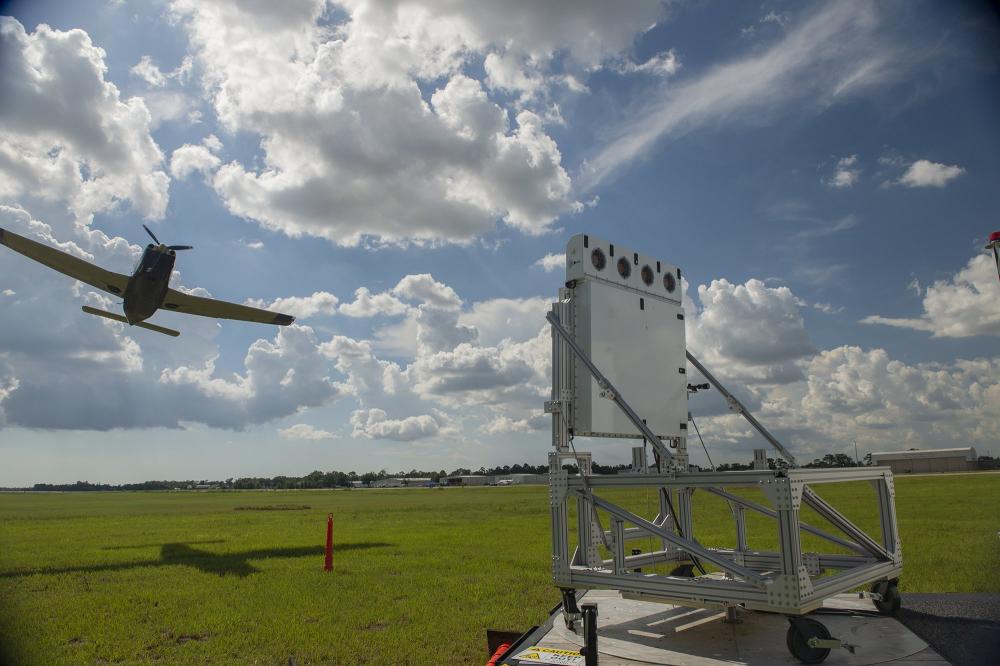 Skyler guides a single engine aircraft on final approach to touchdown during a flight check demonstration.