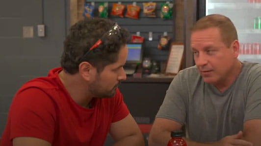 Two men sitting at a lunchroom table