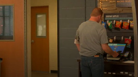 A man making a selection at a vending machine