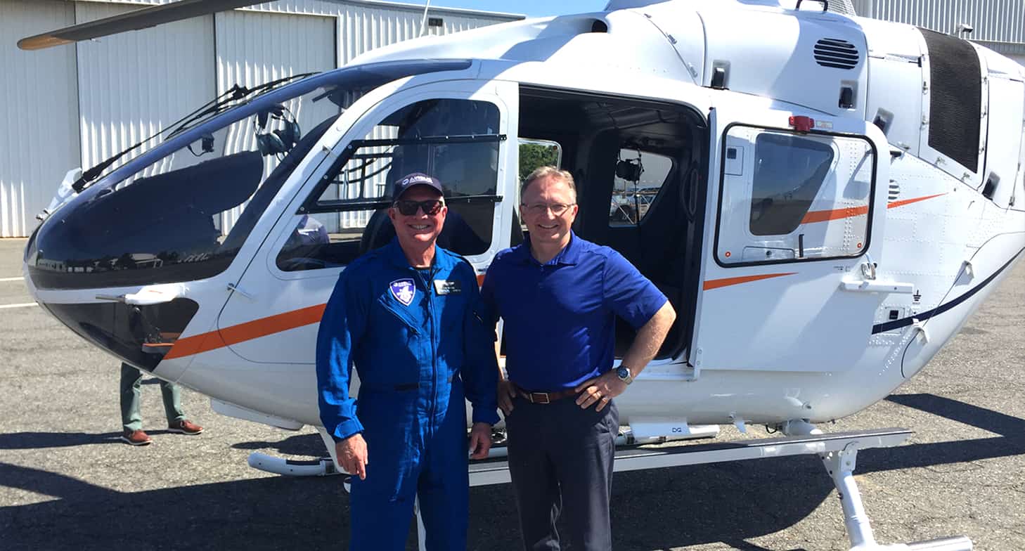 Craig Huisson devant un helicoptere