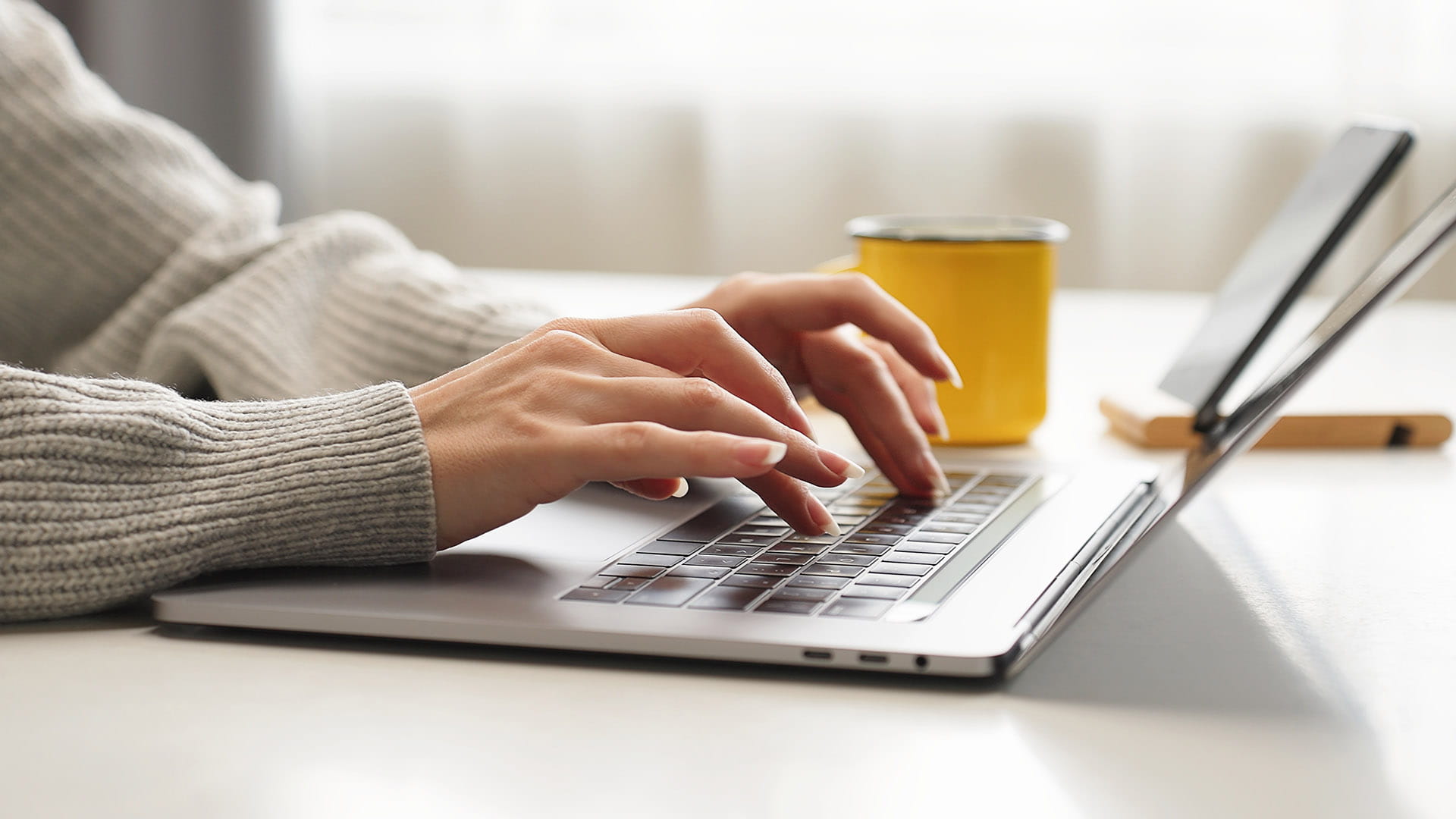 woman typing on a laptop