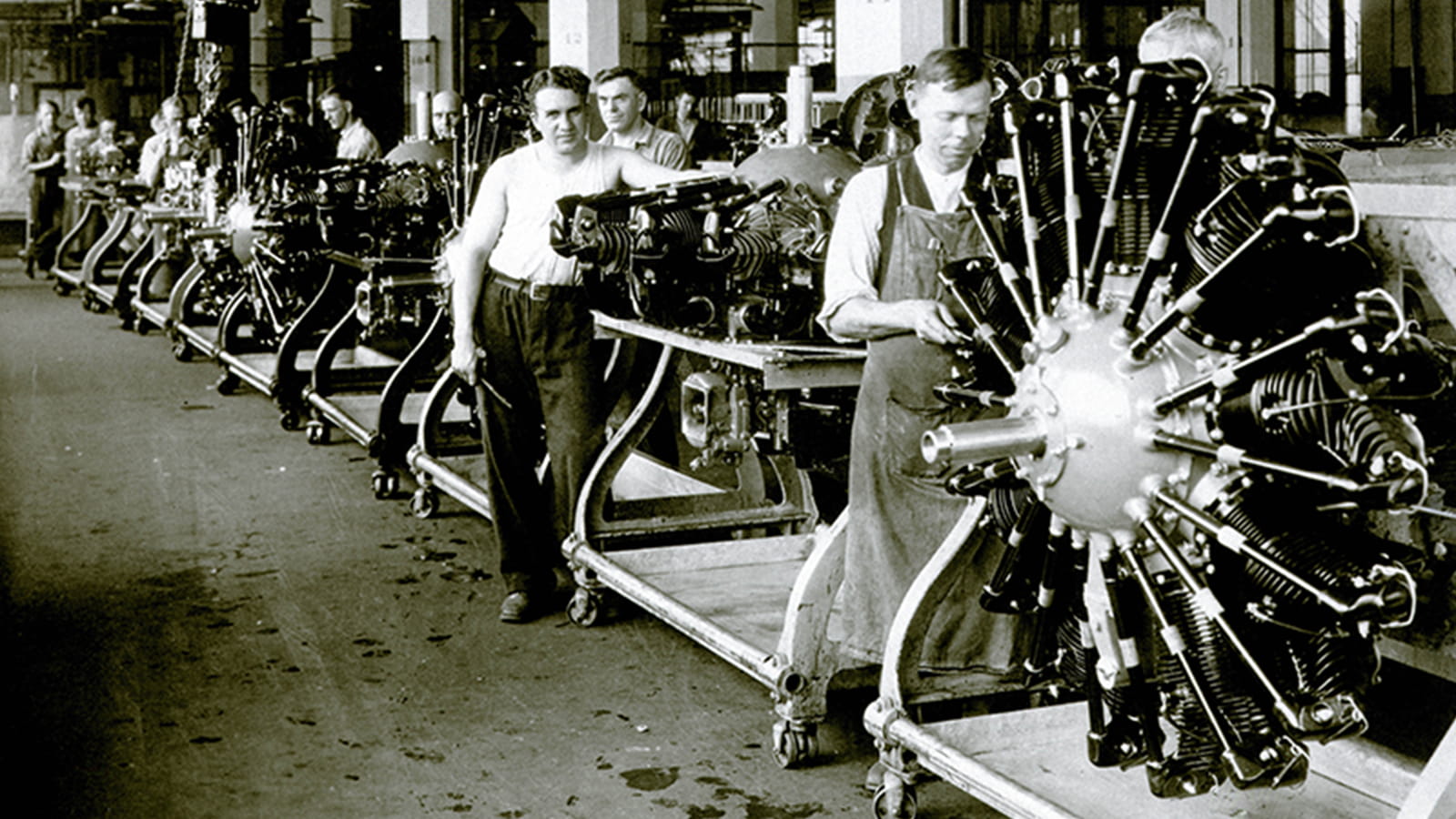old photo of workers assembling a radial engine