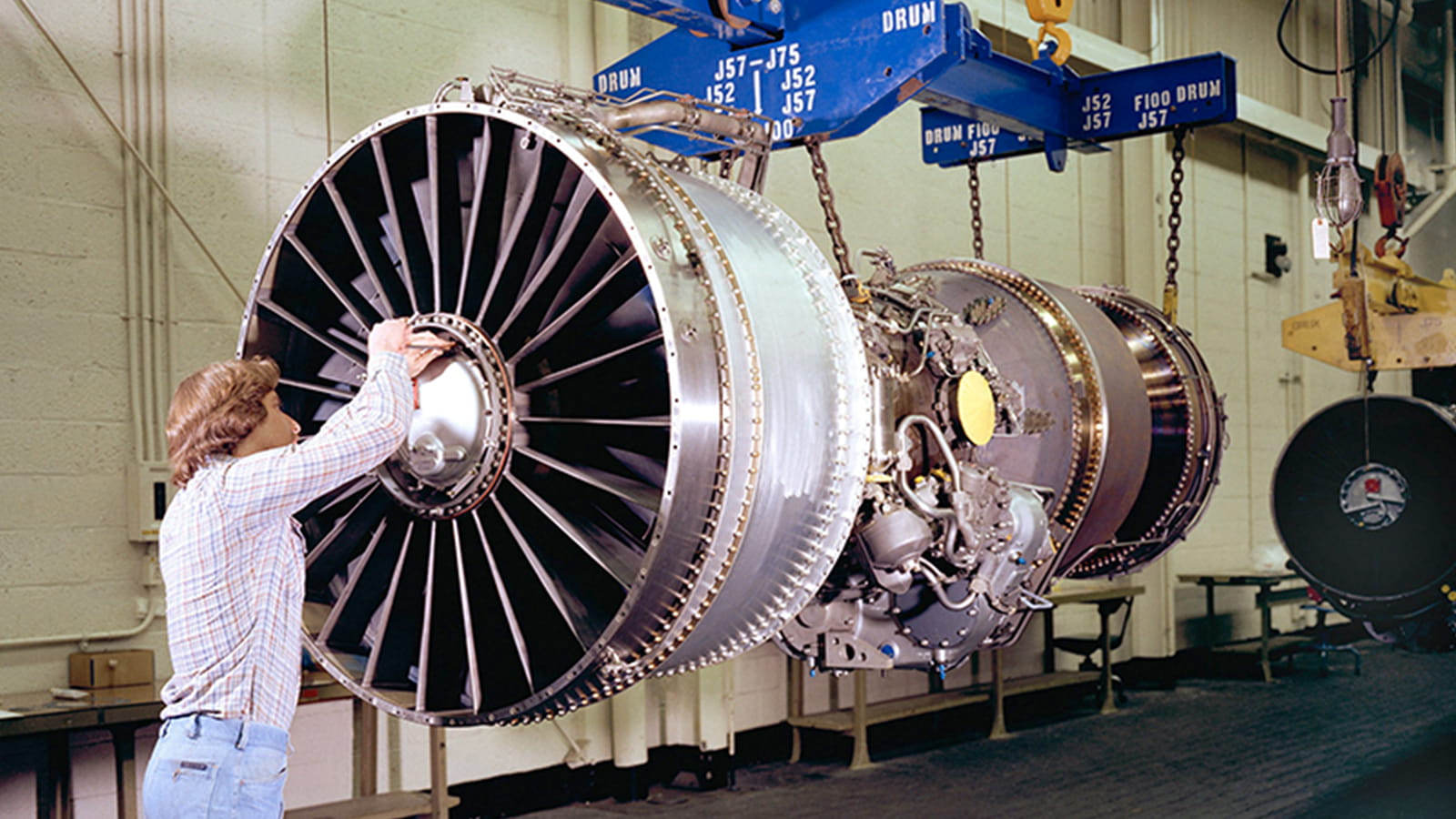 a person working on the assembly of an aircraft engine