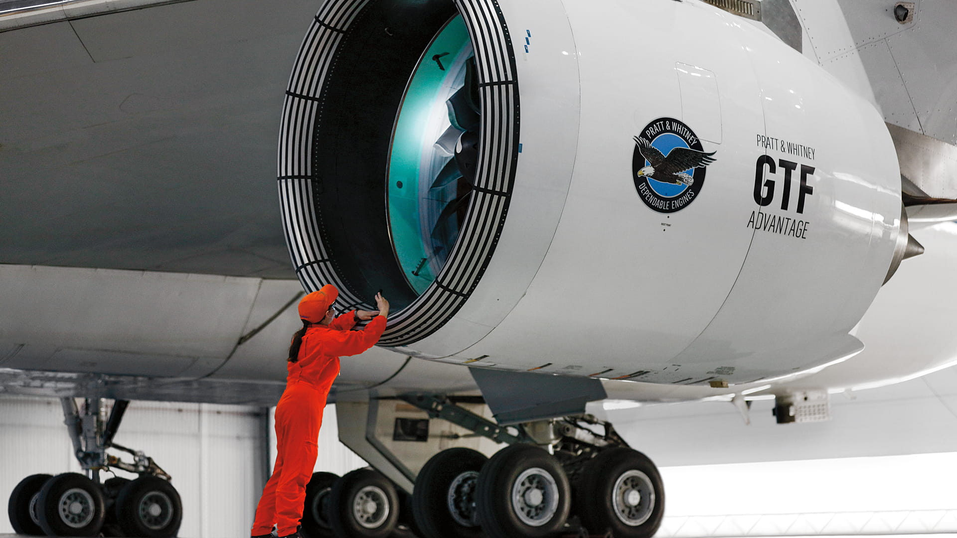 A technician working on an aircraft engine