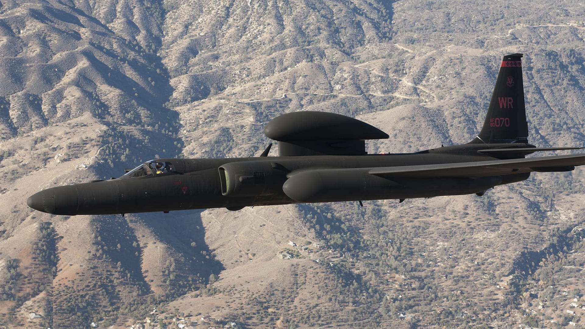 U2 airplane flying above the mountains
