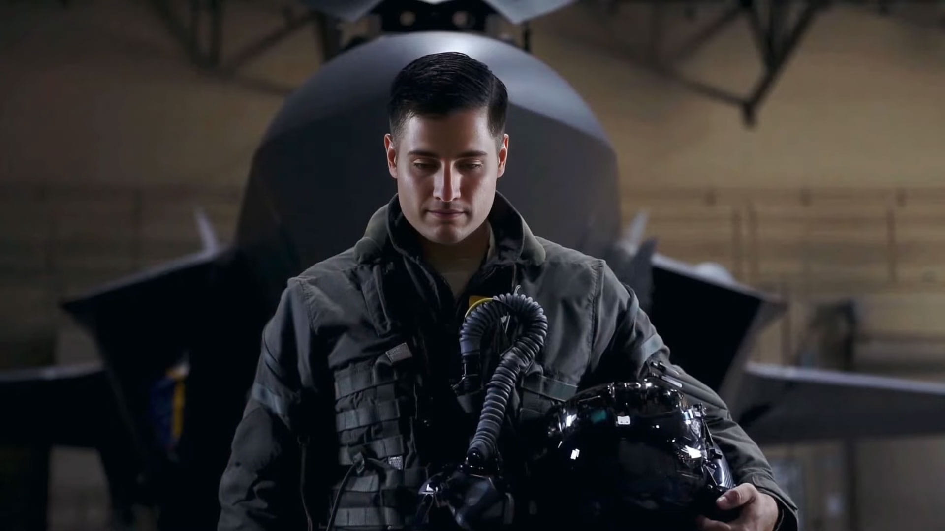 A pilot standing in front of a fighter jet