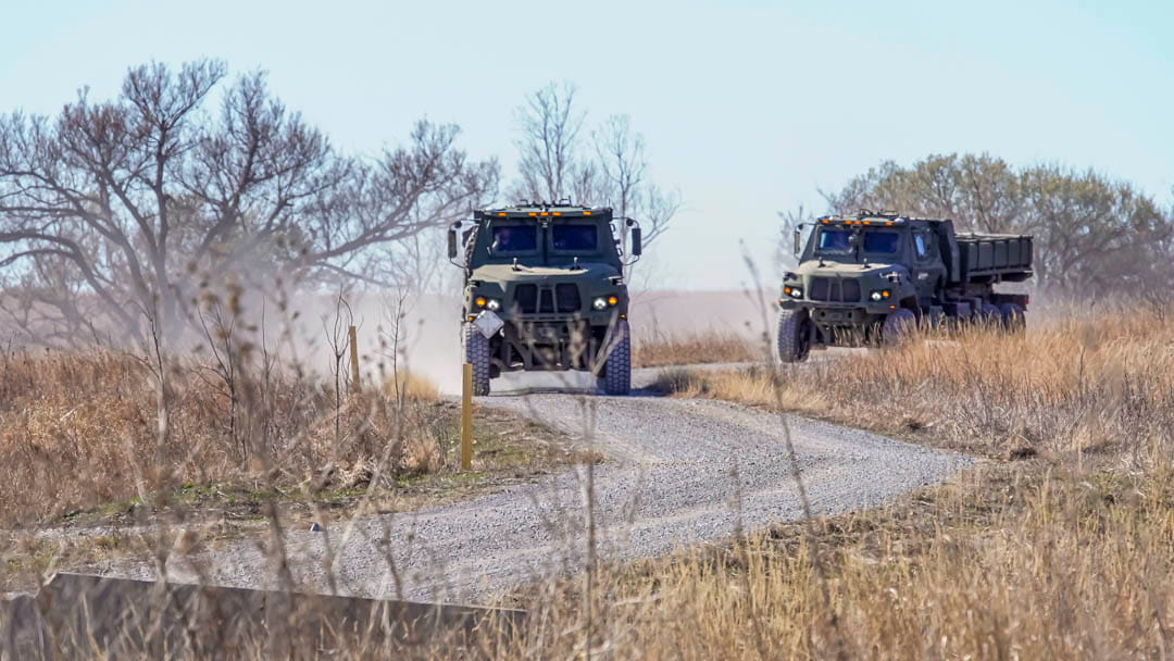 Military vehicles on a dirt road