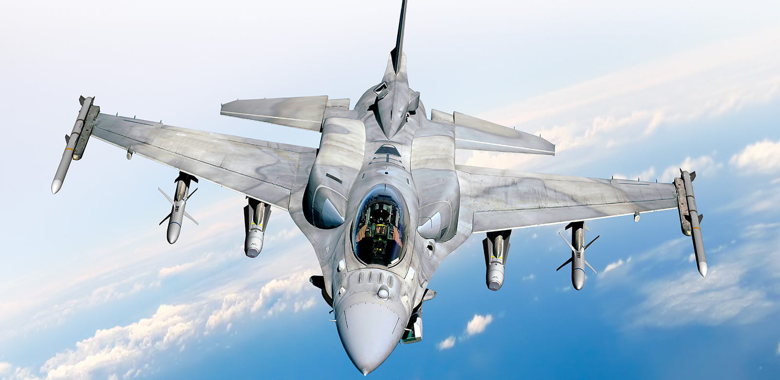 F-35 with missiles on the wings flying through the sky