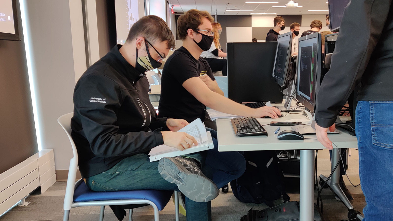 Chris Fischer, foreground, competes in the Rochester Institute of Technology Information Security Talent Search, March 5, 2022.