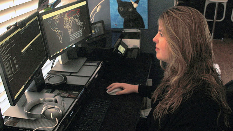 Cyber Engineer Micah Oltmann works from her home office near Denver