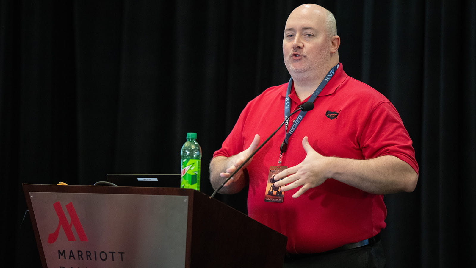 man on stage speaking