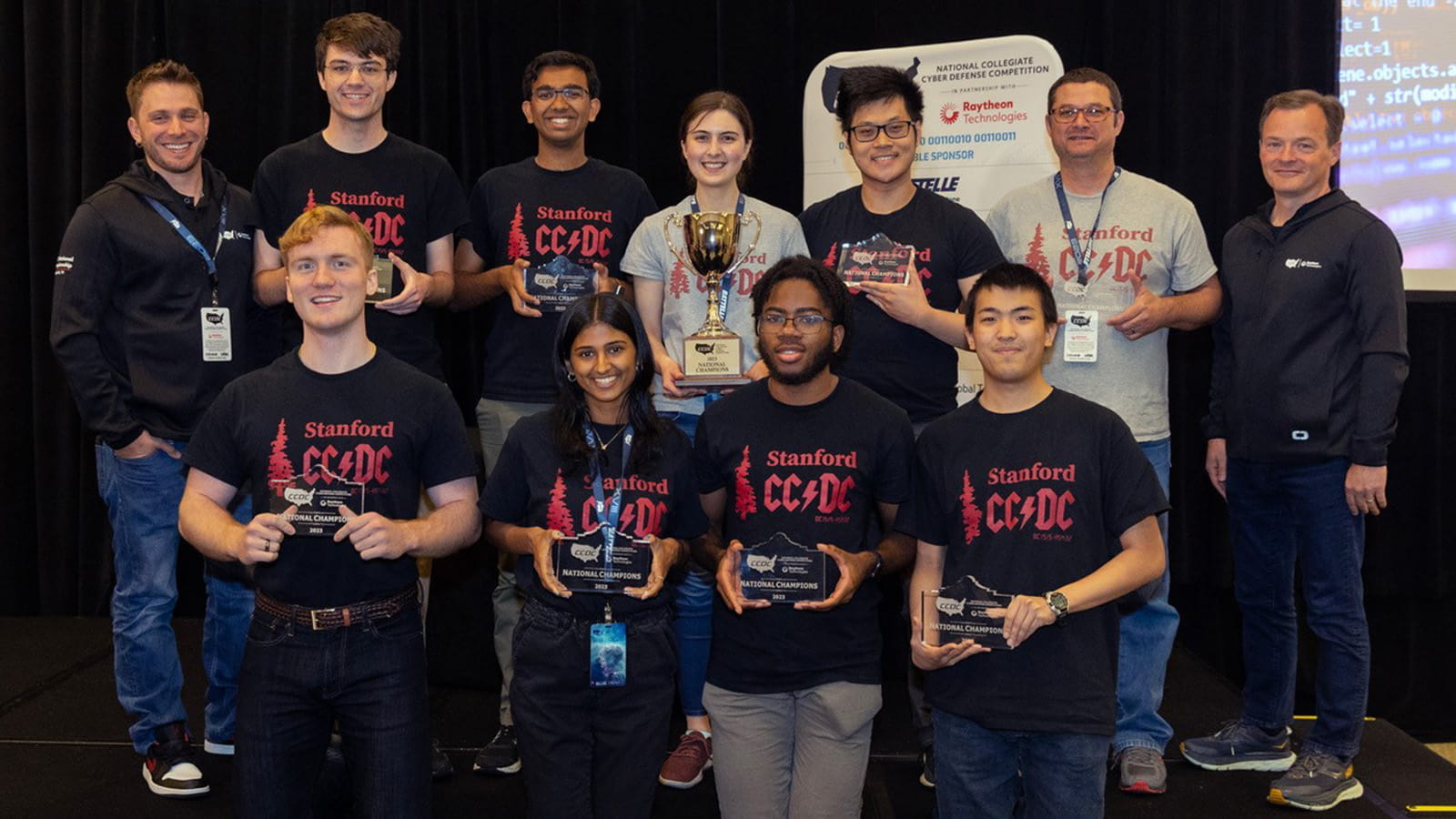 Stanford team on stage with trophies