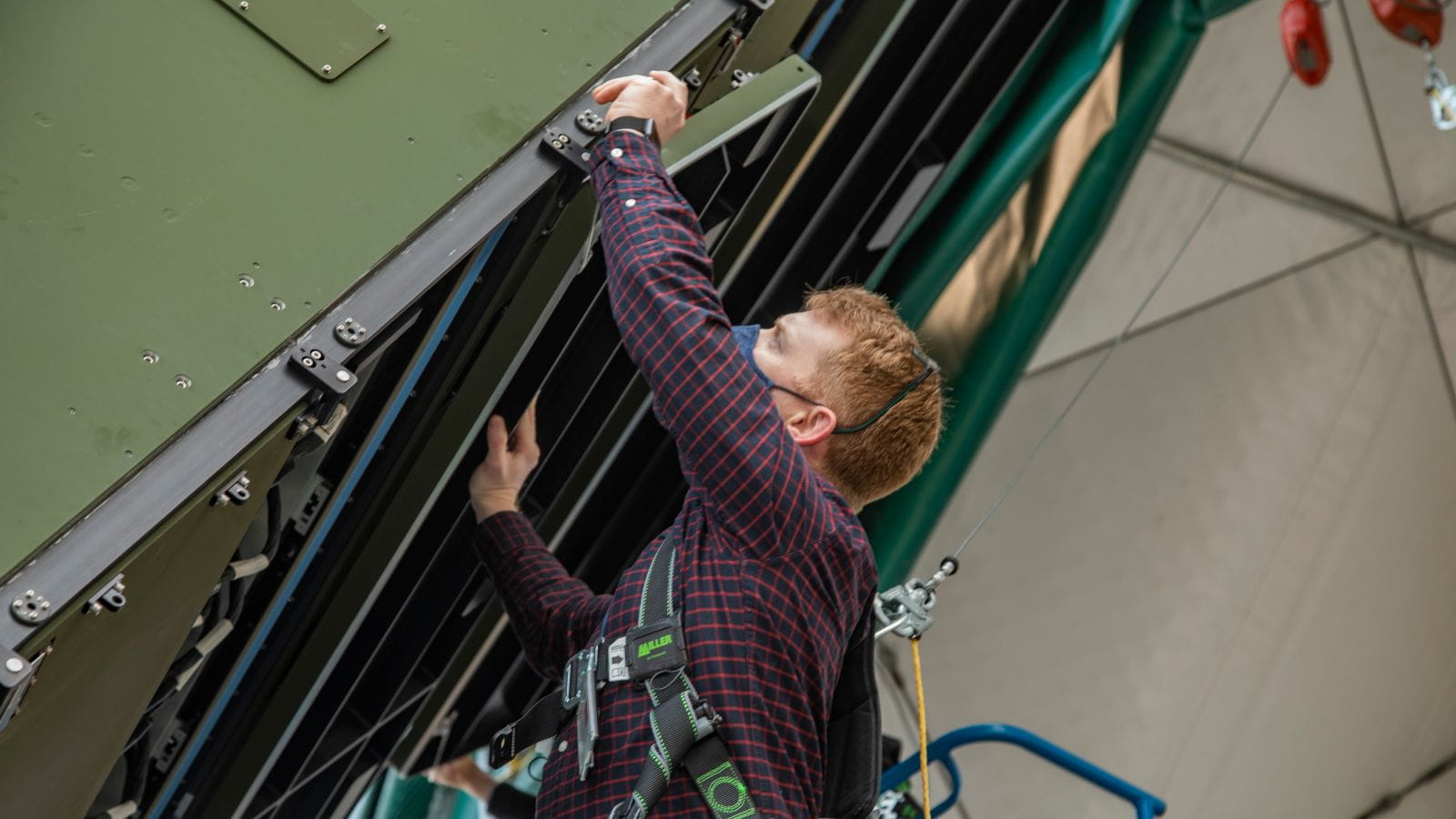 An engineer works on the LTAMDS radar at a test facility.