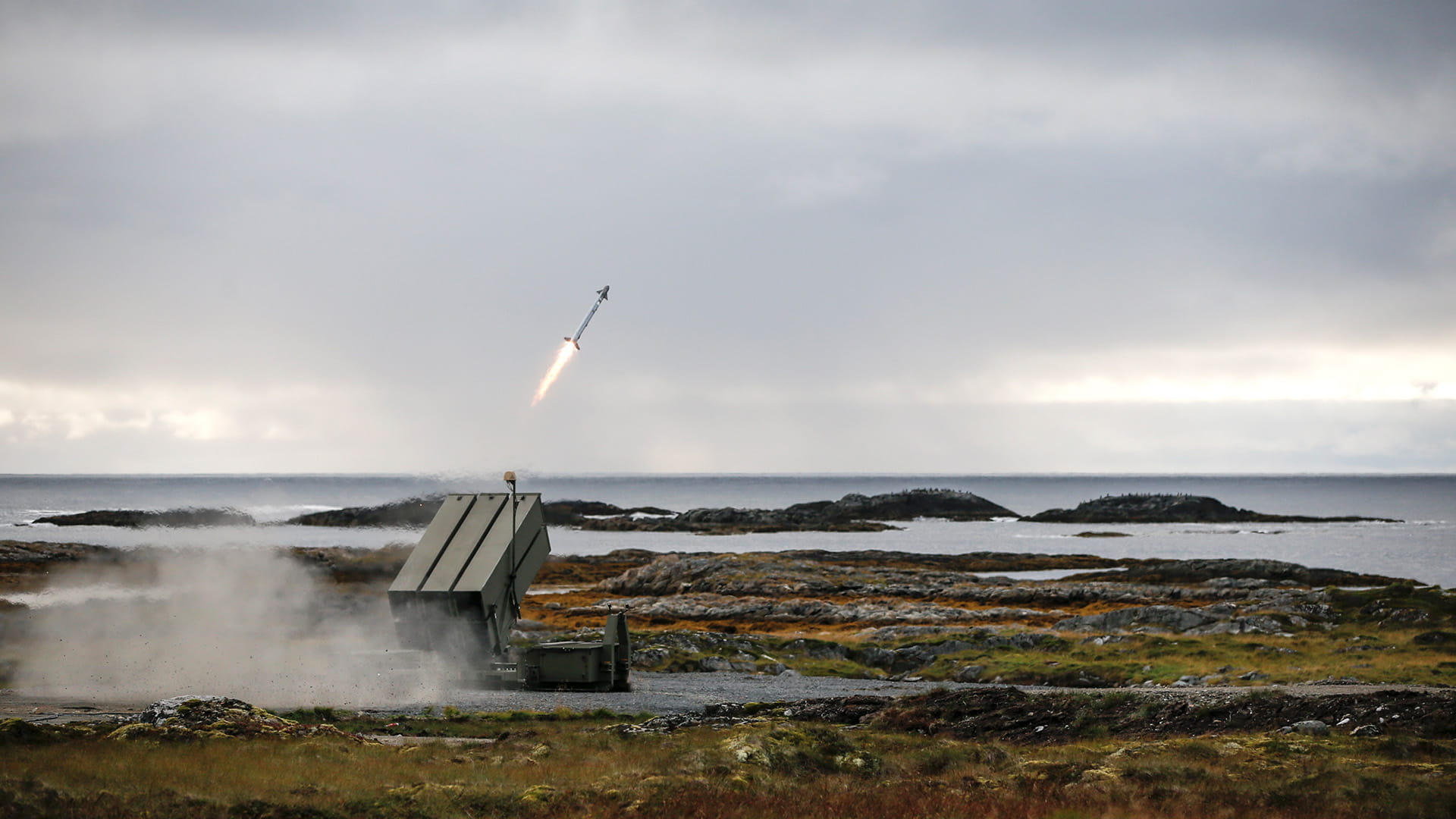 surface-to-air missile launcher firing over sea