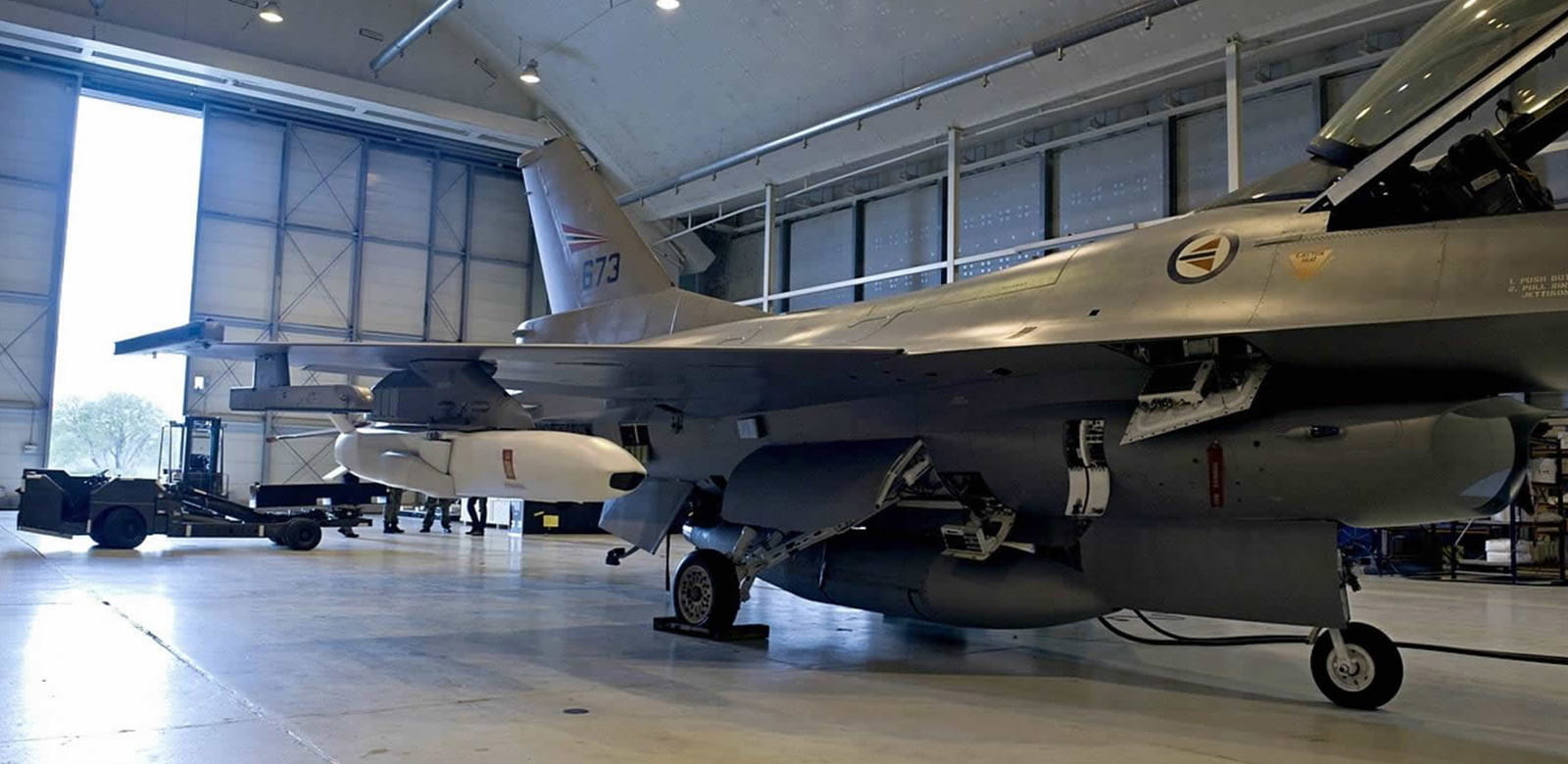 A Joint Strike Missile is pictured on the wing of a Royal Norwegian Air Force F-16 during a fit check.