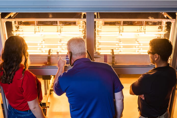 Raytheon Missiles & Defense engineers examine a missile being tested in the tanning bed. 