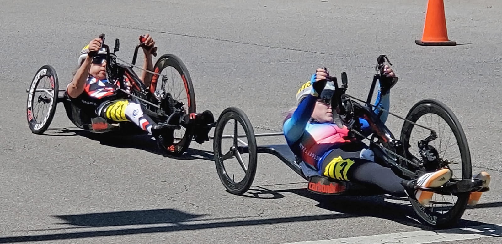 Two athletes on their handcycles, waiting for the race to begin.