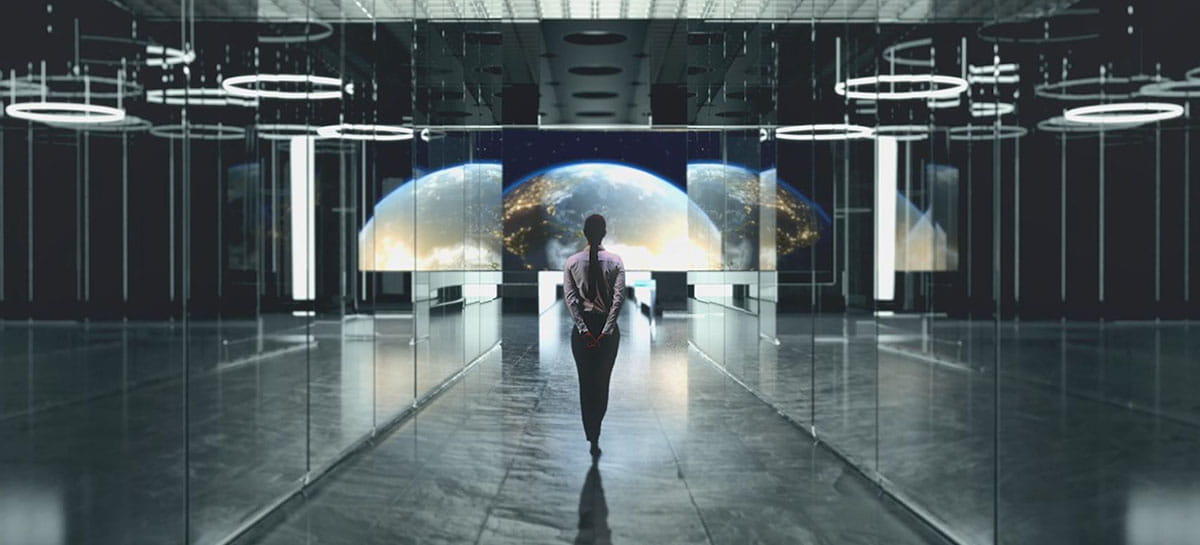 Woman in high tech hallway overlooking space view
