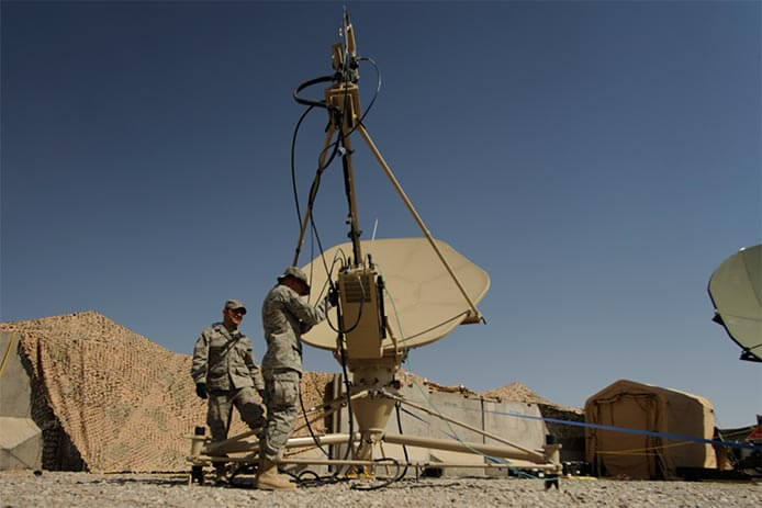 Air Force satellite communications technicians conduct routine maintenance on a satellite dish in Kandahar, Afghanistan.