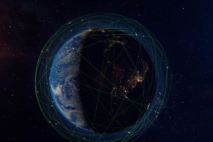 Earth surrounded by a constellation of satellites