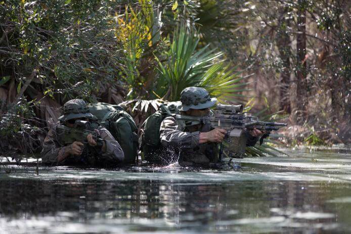 Soldiers on patrol with ELCAN rifle sights.