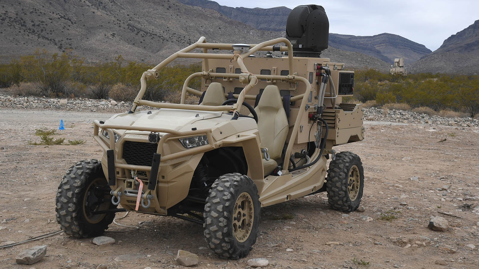The High-Energy Laser Weapon System, mounted on a tactical military vehicle, demonstrates interoperability with the NASAMS air defense system at White Sands Missile Range.