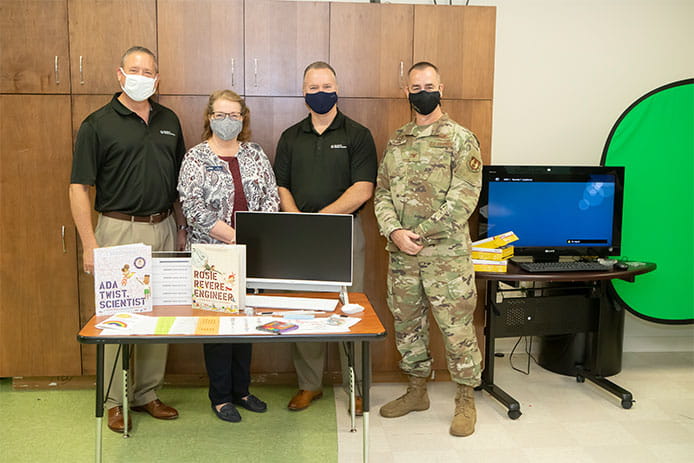 Raytheon Missiles & Defense employees deliver STEM kits to the Eglin Air Force Base Youth Center.