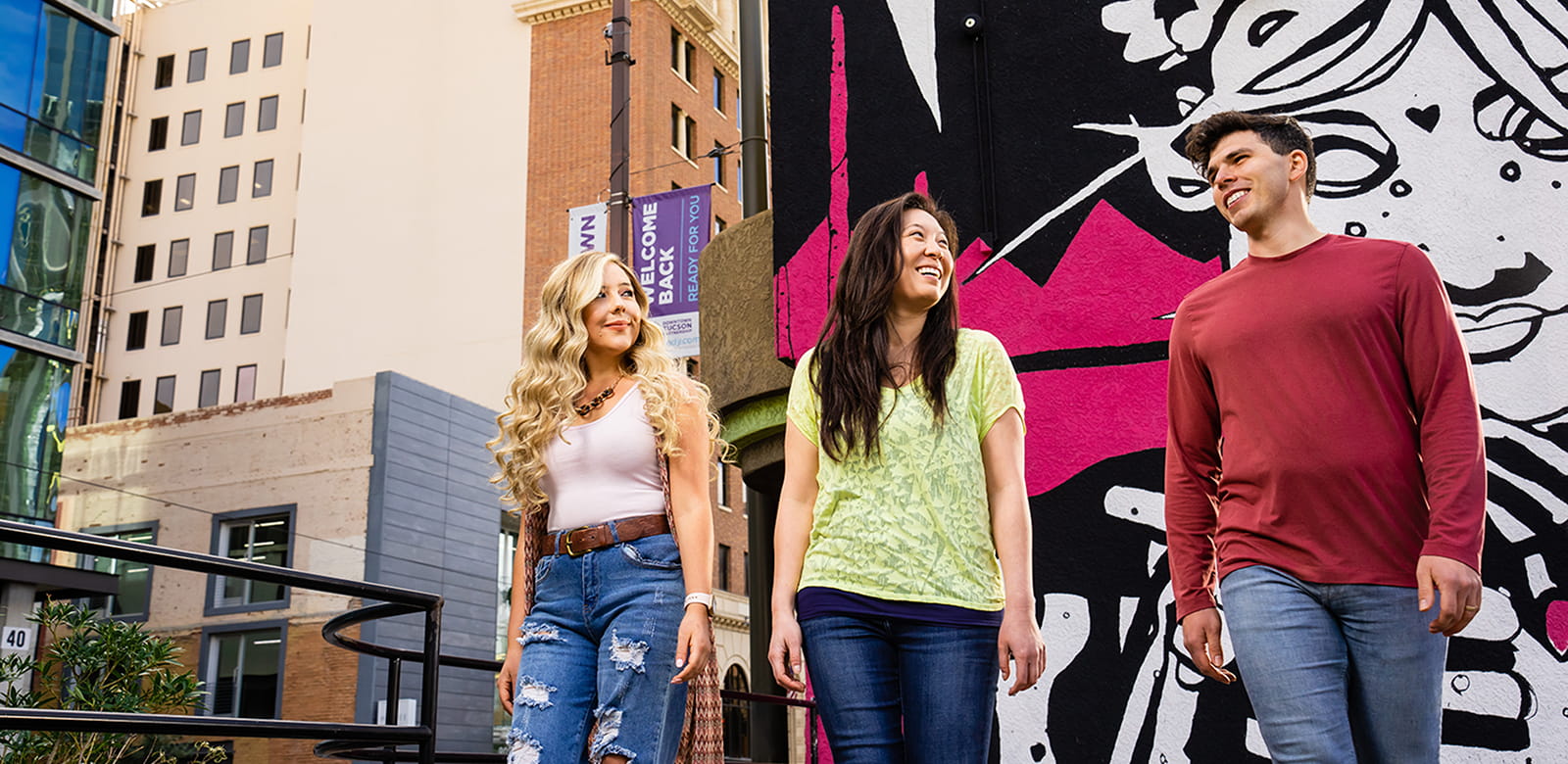 Three friends enjoy the popular Mural Walk in Tucson.