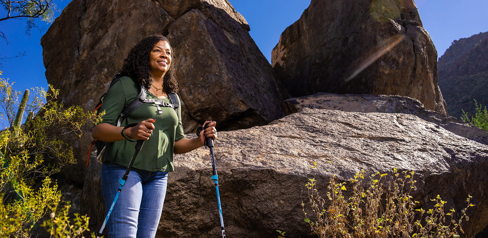 An employee is shown hiking in Gates Pass.