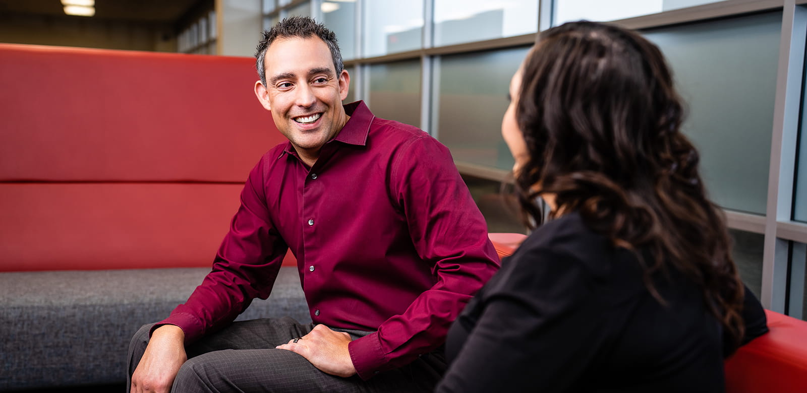 Two employees chatting in the office.