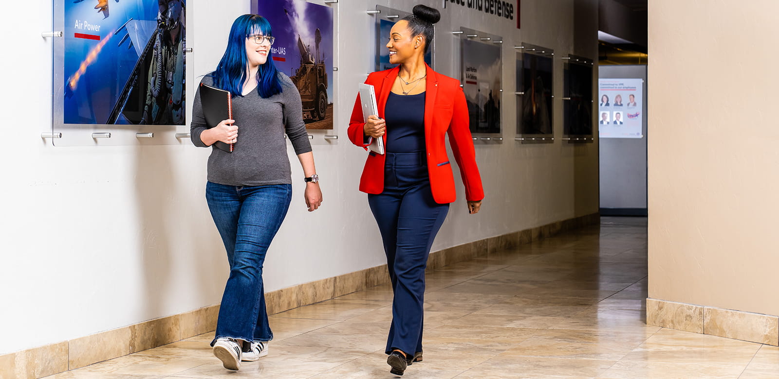 Two employees walk down the hall of our Tucson office.