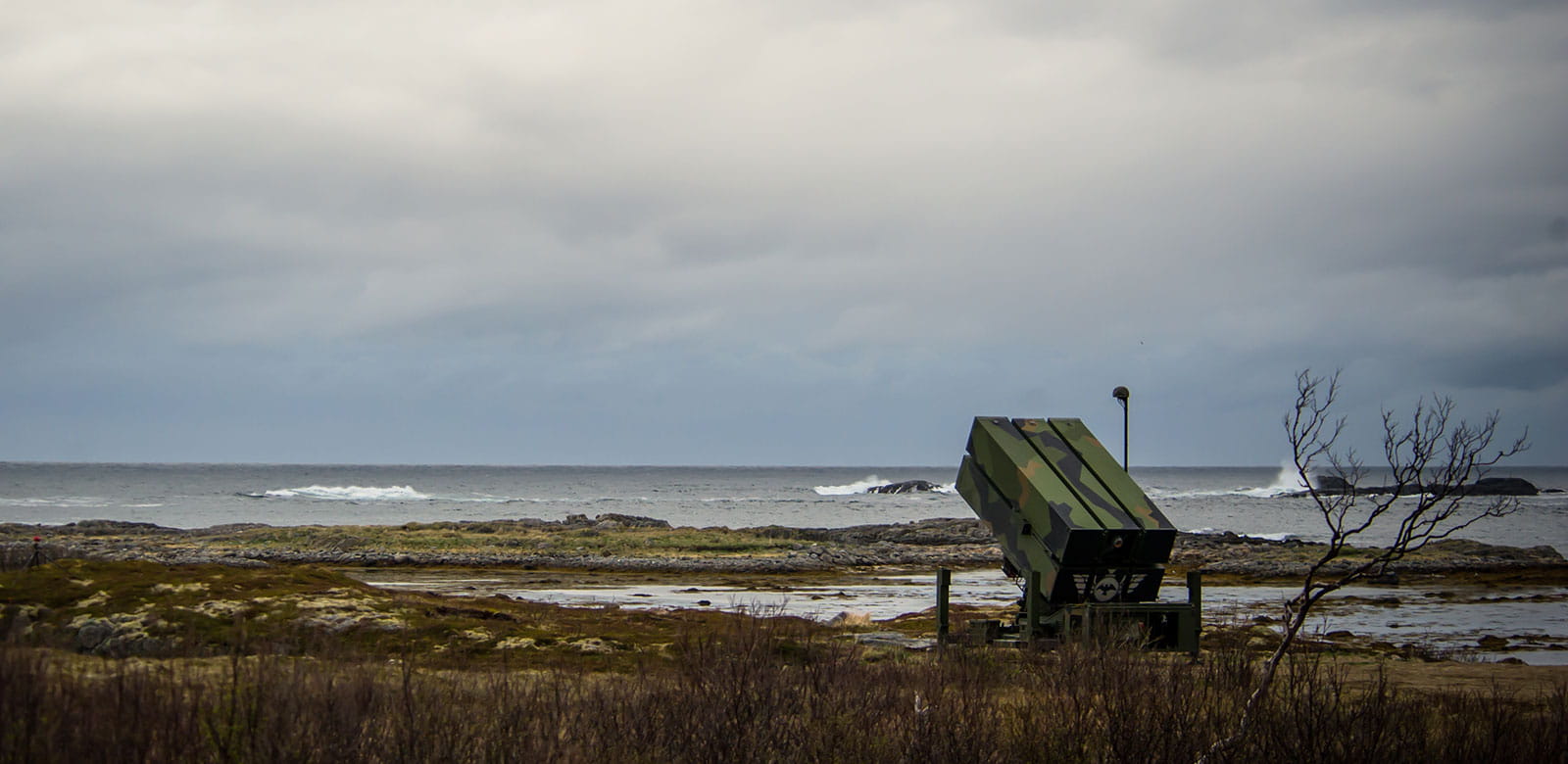 A surface-to-air missile launcher set on a beach.