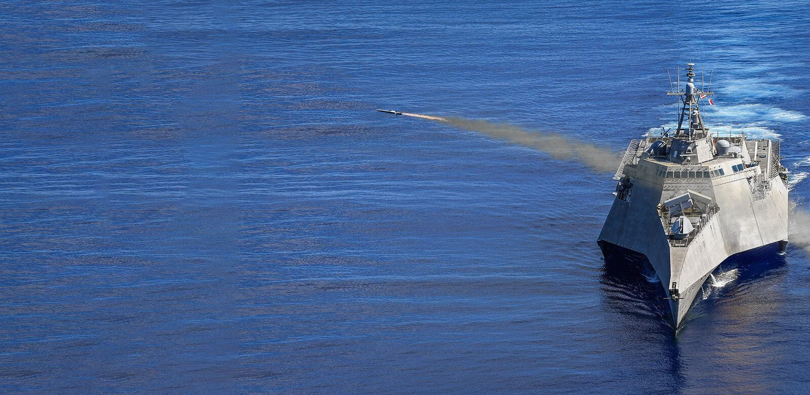 The Naval Strike Missile flies over the ocean. 
