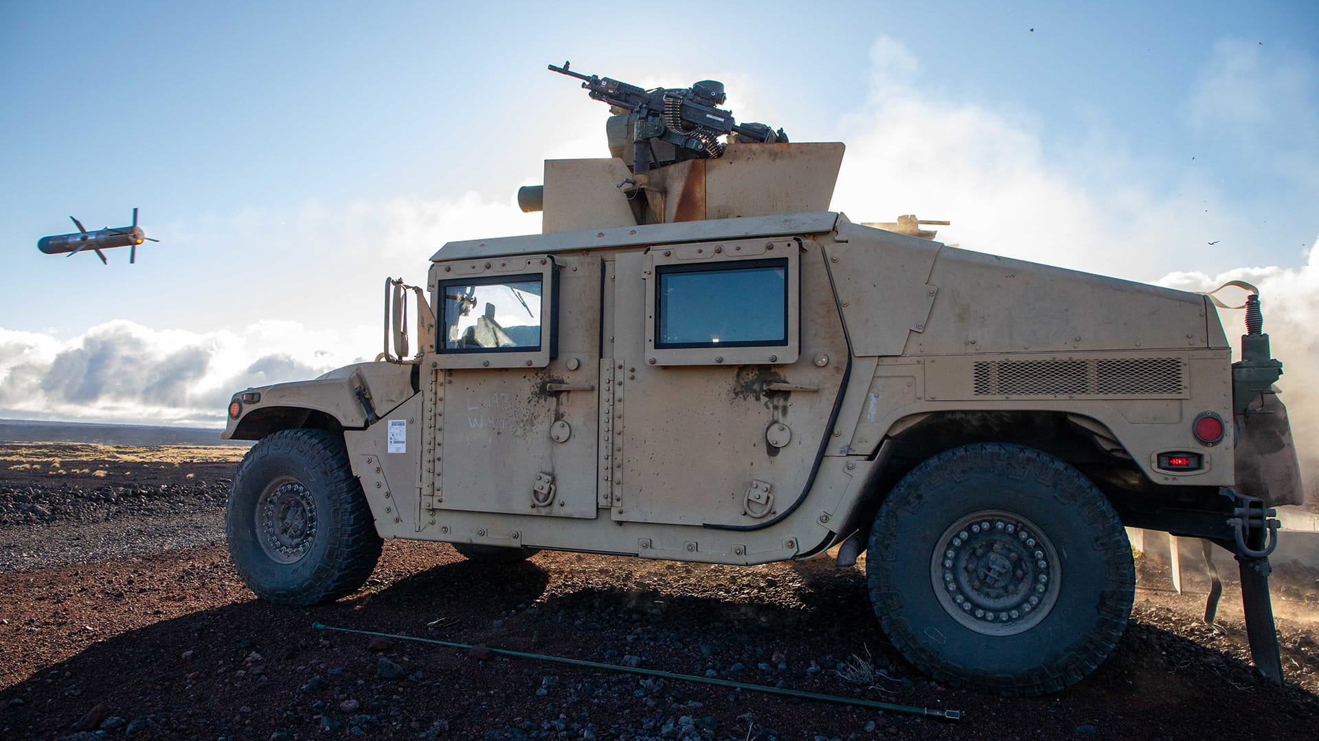 Tank with a Tow weapon launcher shooting a missile