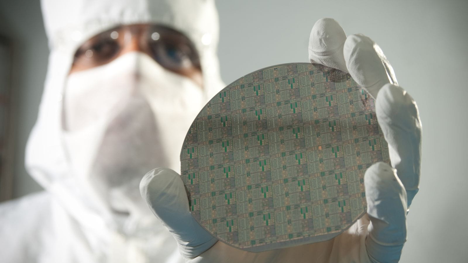 An engineer holds a gallium nitride semiconductor.
