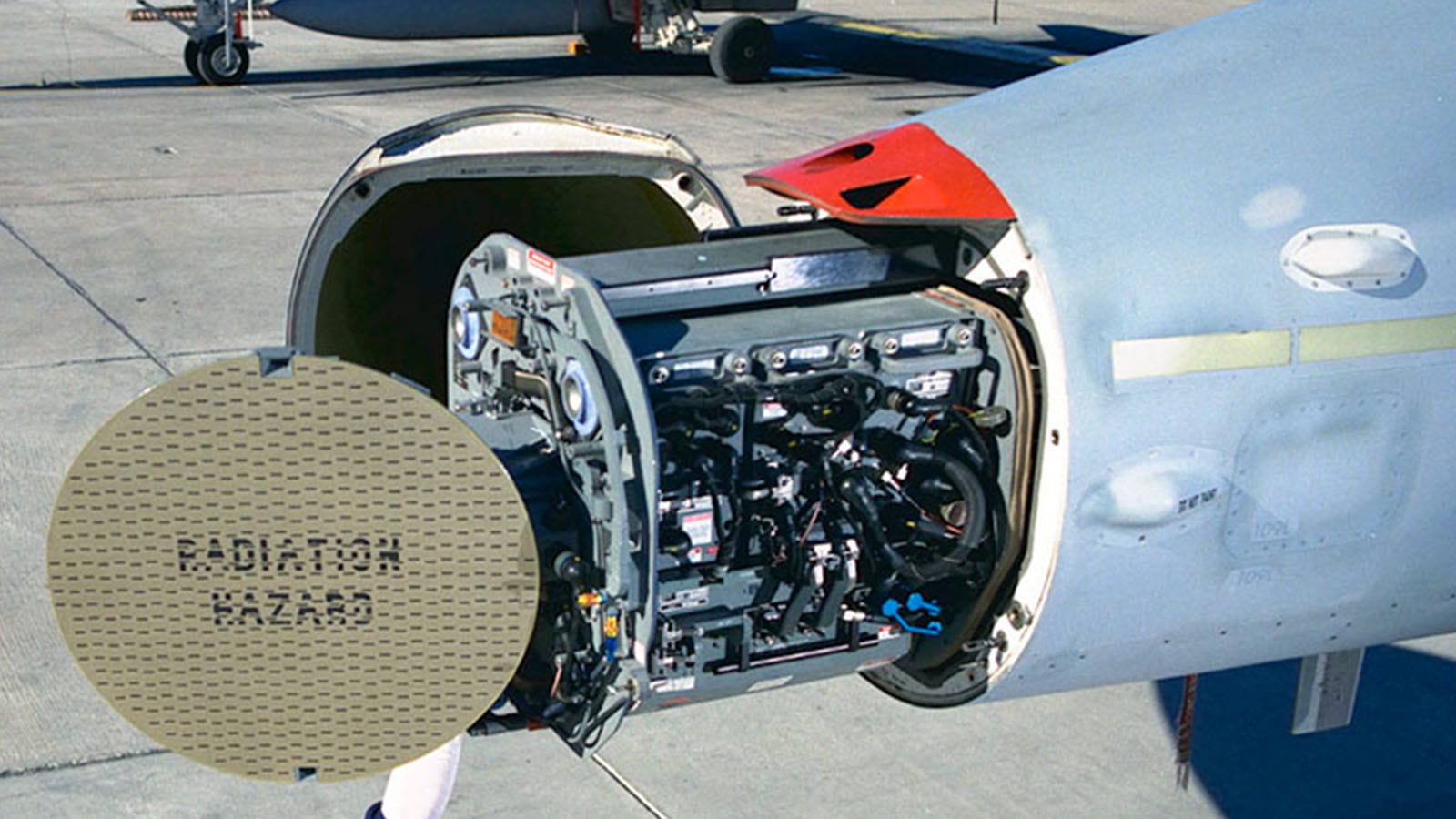 An APG-73 fire control radar is installed into an F/A-18 Hornet. The radome swings open and the radar glides forward on rails to allow access to the entire system.