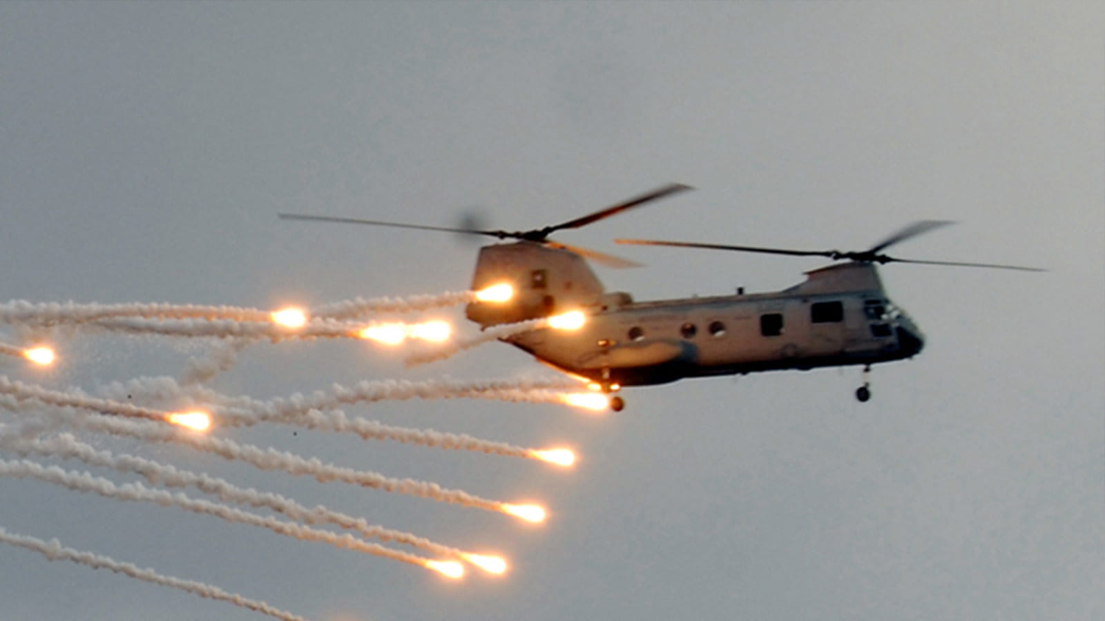 Chinook in flight trailed by flares