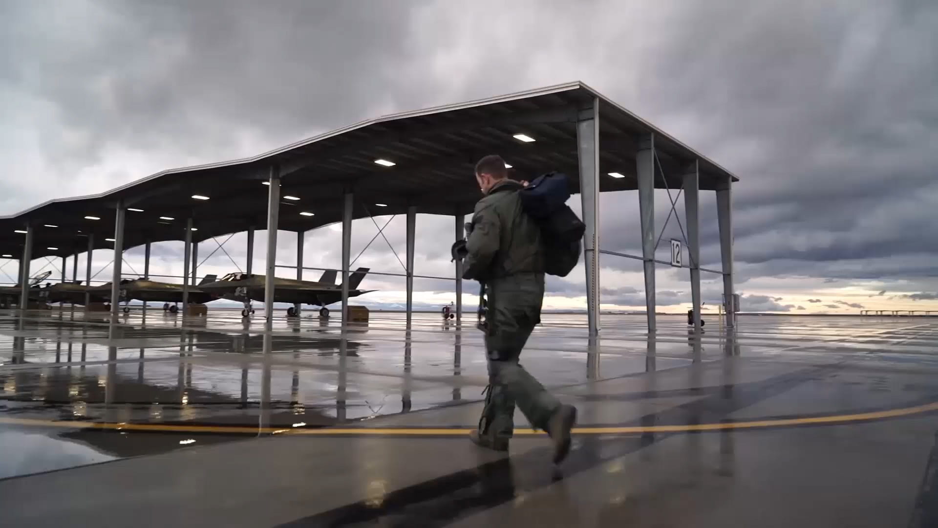 Pilot walking in front of F-35s