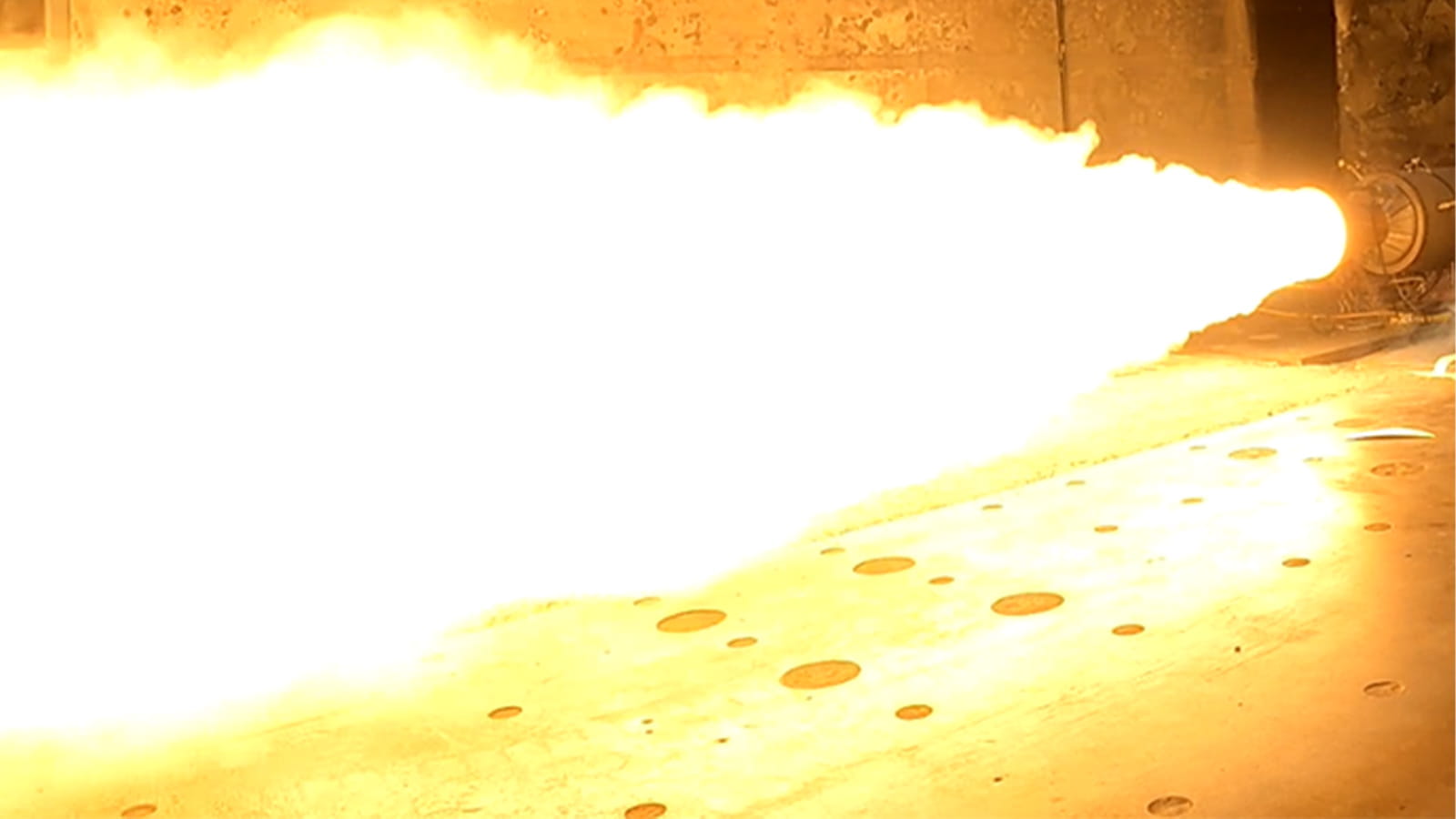 flames shooting out of a rocket in a test cell